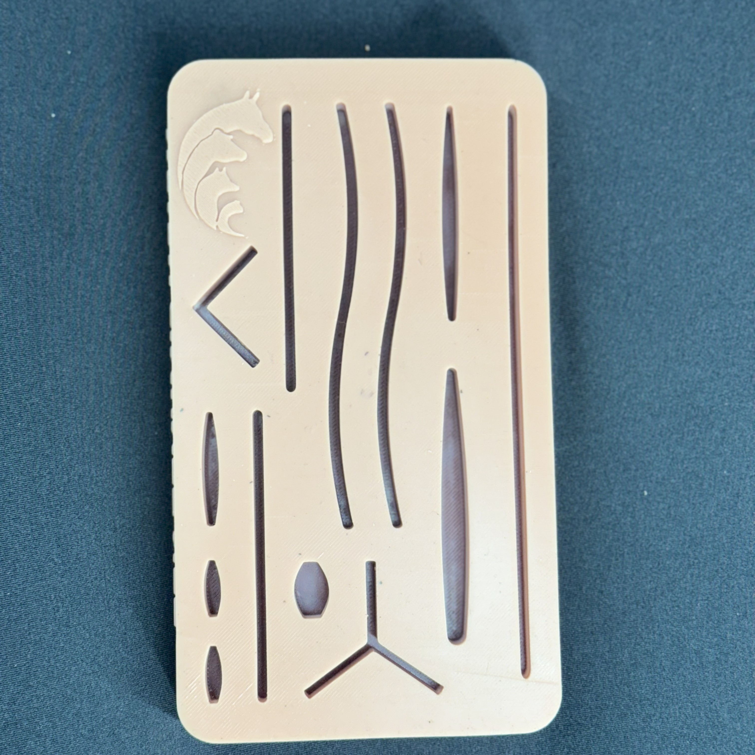 Silicone suture pad reinforced with two mesh layers